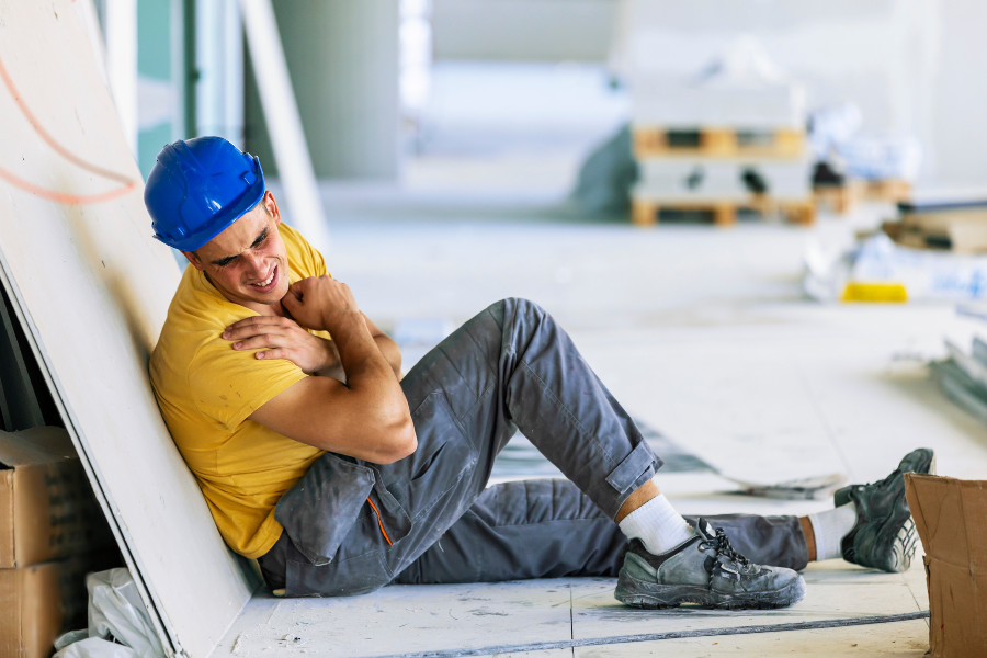 Construction worker experiencing shoulder pain after a workplace incident